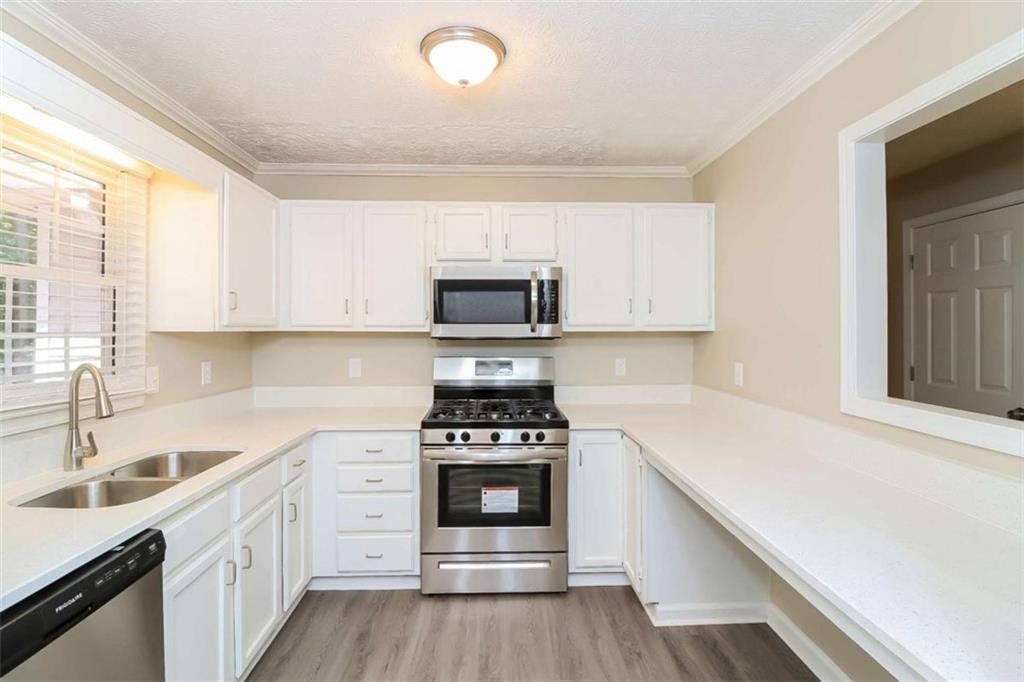 133 Johnstons Way Dallas, GA 30132 - Photo 5 of 15 a kitchen with a sink stove top oven and cabinets