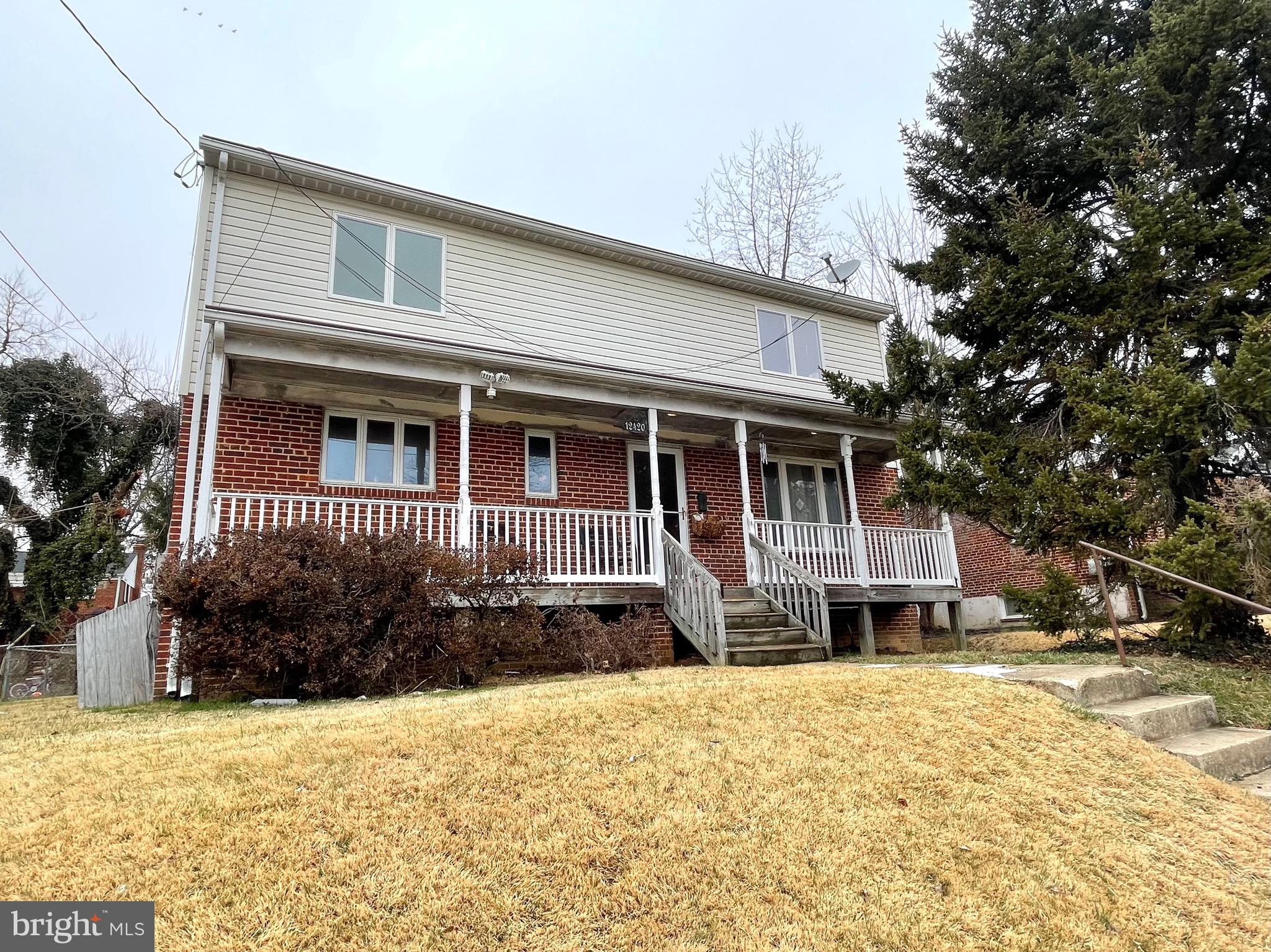 12420 Feldon Street Silver Spring, MD 20906 - Photo 1 of 33 a front view of a house with a yard covered with snow