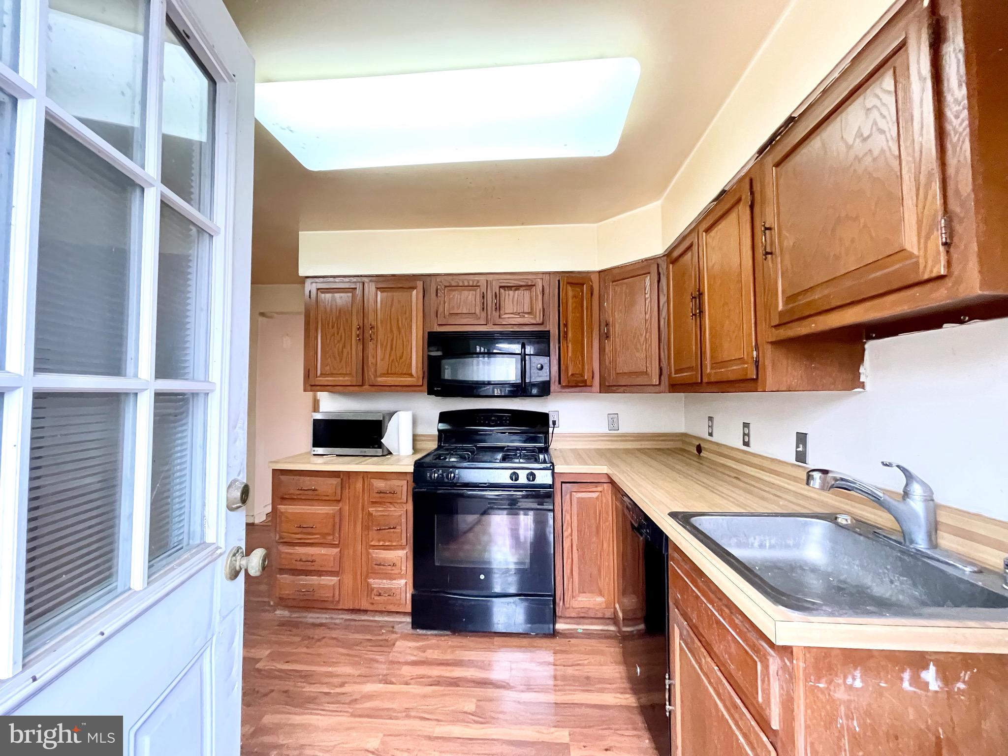 12420 Feldon Street Silver Spring, MD 20906 - Photo 9 of 33 a kitchen with stainless steel appliances granite countertop a stove a sink and a microwave