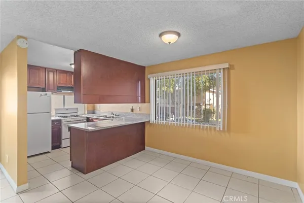 a view of kitchen with granite countertop cabinets and sink