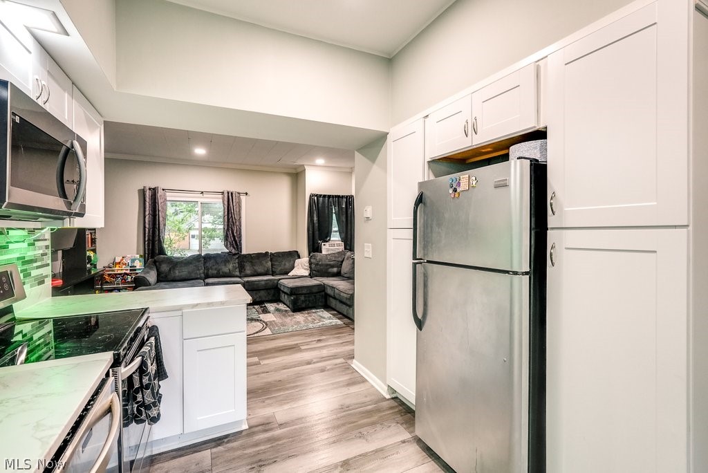 195 Canton Road Akron, OH 44312 - Photo 21 of 29 Kitchen featuring light stone counters, light hardwood / wood-style floors, white cabinets