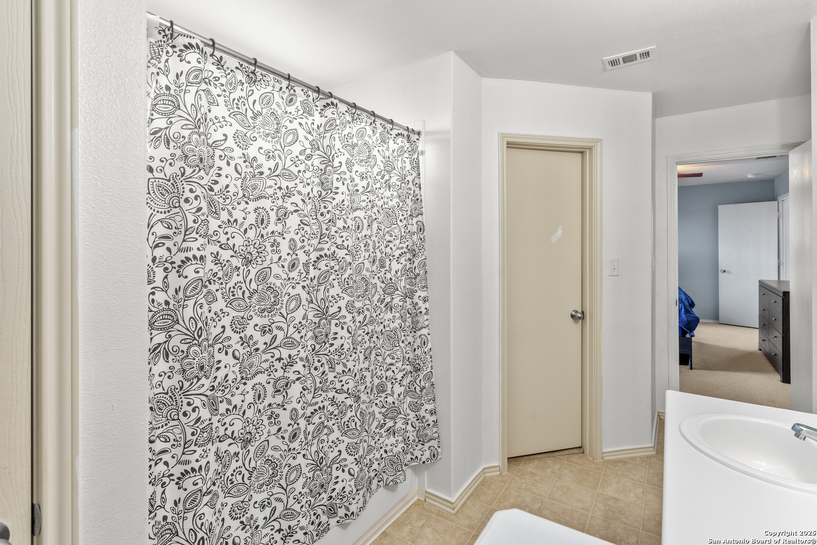 3917 Whisper Ridge Schertz, TX 78108 - Photo 19 of 27 a bathroom with a shower curtain and a sink