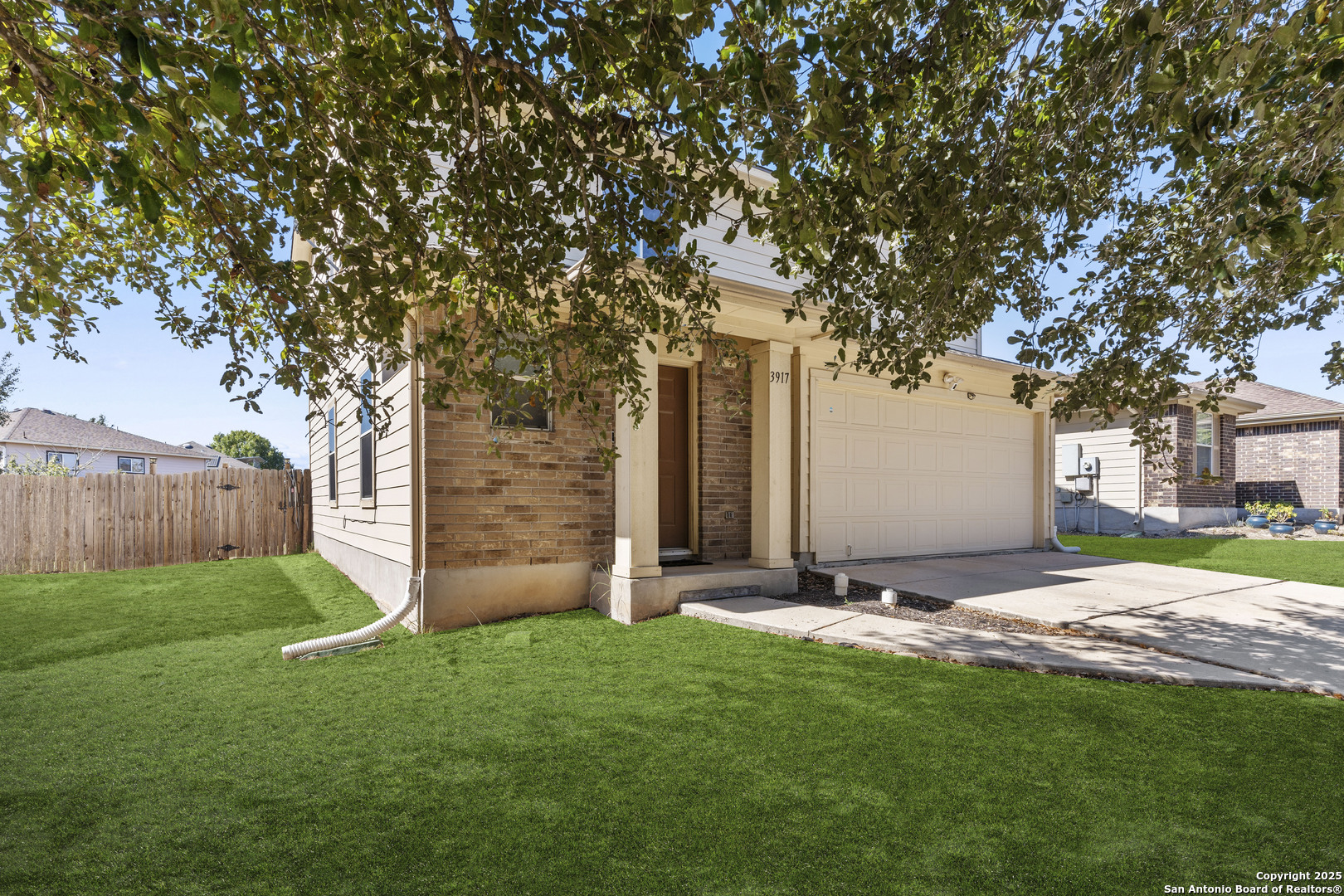 3917 Whisper Ridge Schertz, TX 78108 - Photo 2 of 27 a view of a backyard with a large tree