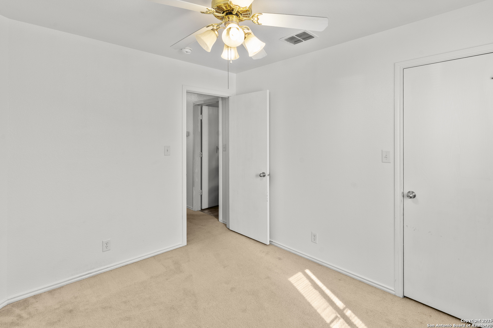 3917 Whisper Ridge Schertz, TX 78108 - Photo 21 of 27 an empty room with a ceiling fan and a window