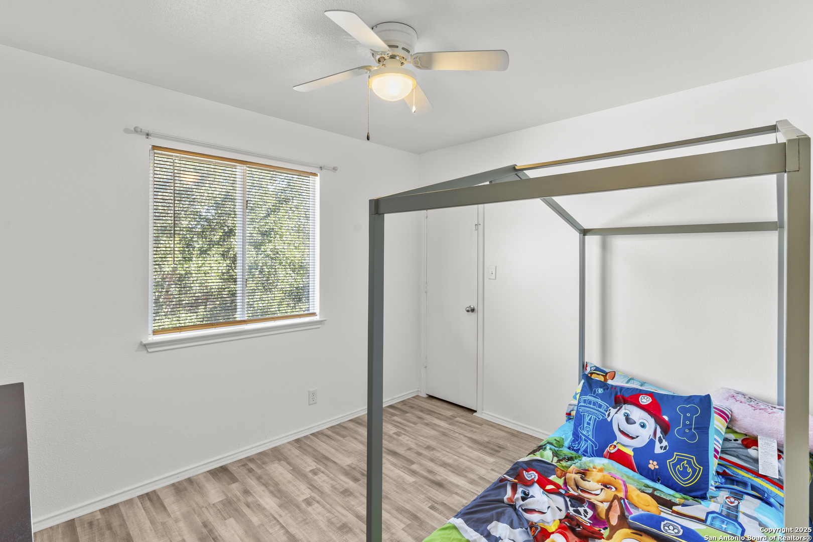 3917 Whisper Ridge Schertz, TX 78108 - Photo 22 of 27 a bedroom with a bed and a chandelier