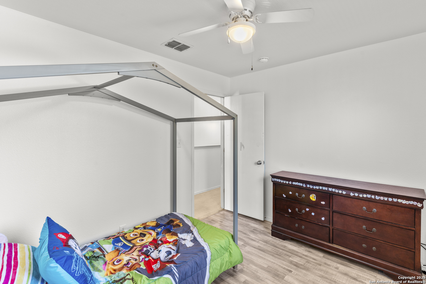 3917 Whisper Ridge Schertz, TX 78108 - Photo 23 of 27 a bedroom with a bed and a dresser