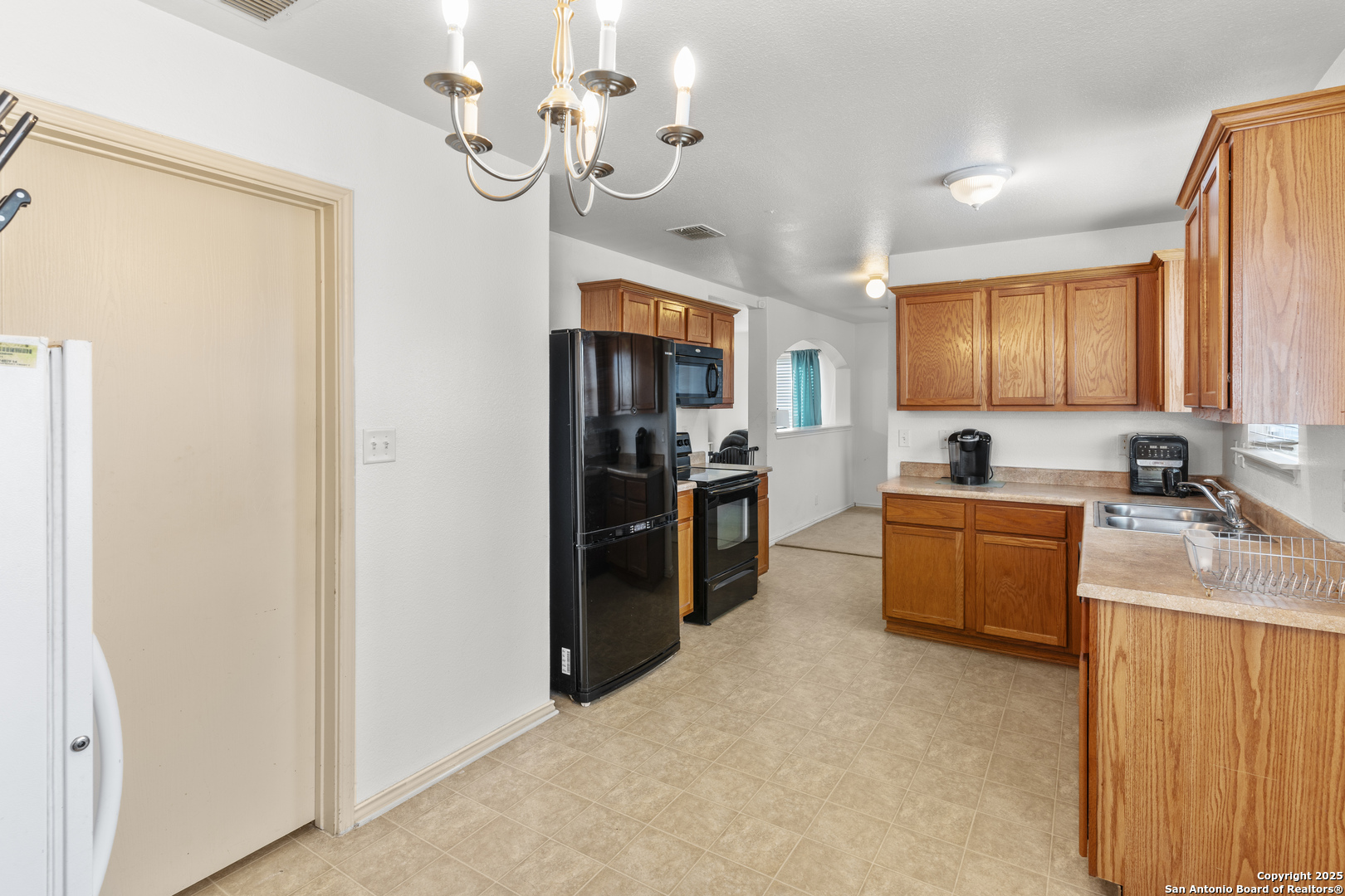 3917 Whisper Ridge Schertz, TX 78108 - Photo 10 of 27 a kitchen with stainless steel appliances granite countertop a refrigerator a stove top oven a sink and dishwasher