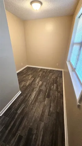 a view of walk in closet with wooden floor and stairs