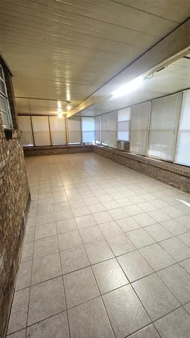 a view of an empty room and wooden floor