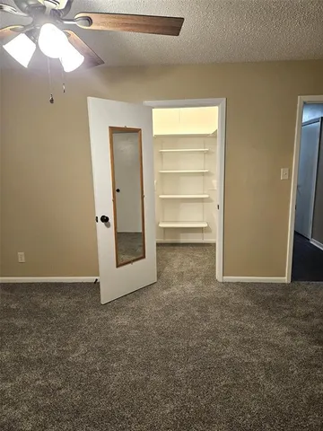 en empty room with windows and closet