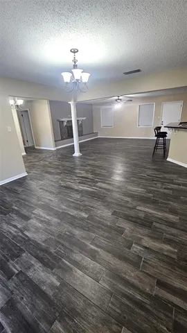 a view of a room with wooden floor