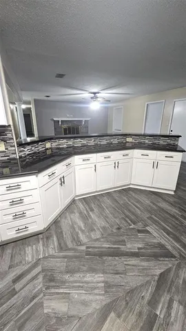 a view of a kitchen with kitchen island and stainless steel appliances