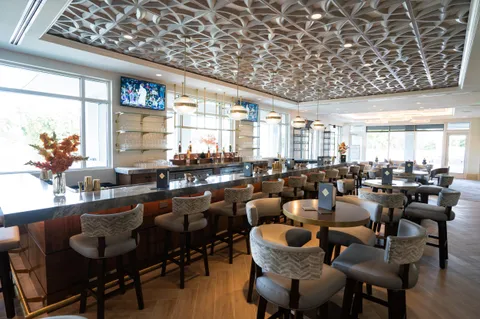 a view of a room with lots of furniture and wooden floor