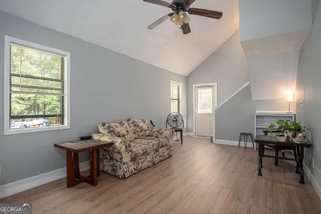 a living room with furniture and a wooden floor