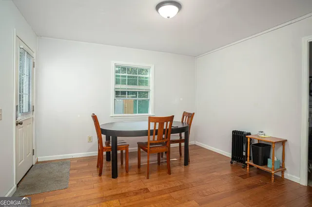 a view of a dining room with furniture and wooden floor