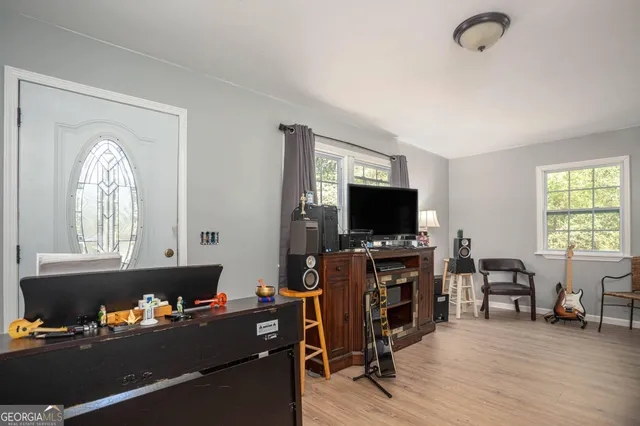 a living room with furniture and a flat screen tv