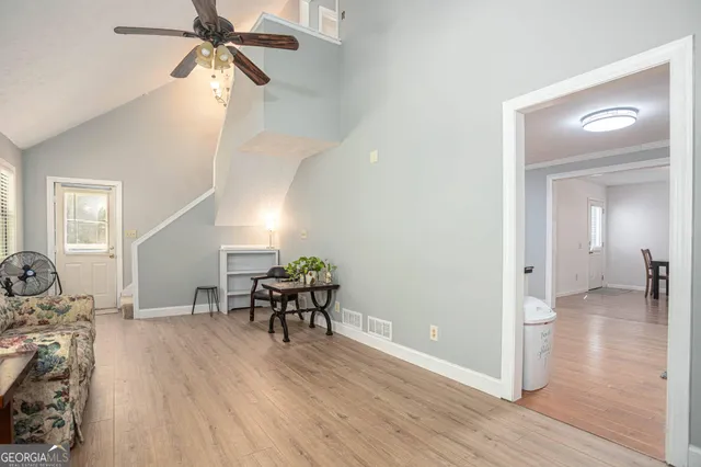 a view of a livingroom with furniture and hardwood floor