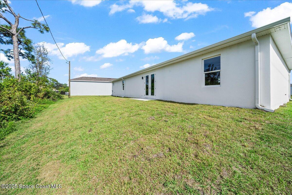 1401 Wilder Road Palm Bay, FL 32909 - Photo 20 of 21 a view of an house with backyard and garden