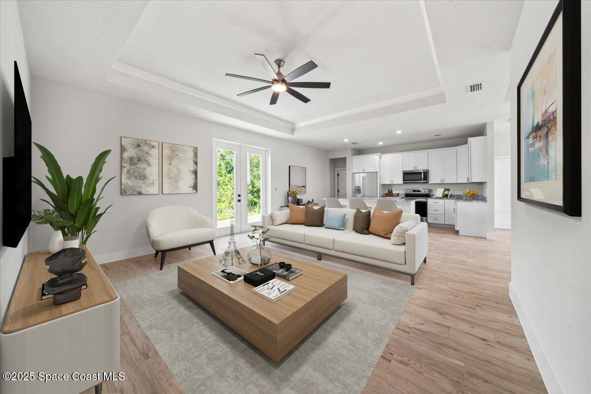 1401 Wilder Road Palm Bay, FL 32909 - Photo 2 of 21 a living room with furniture kitchen view and a potted plant