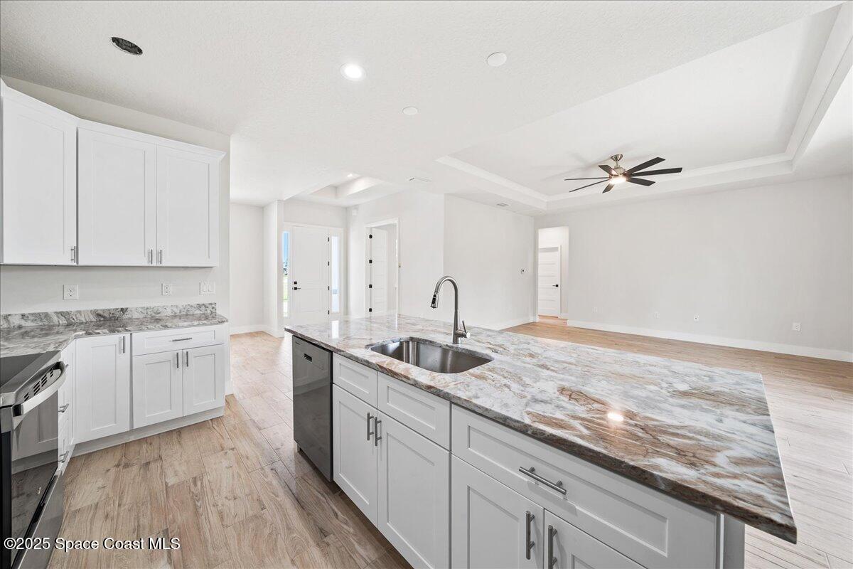 1401 Wilder Road Palm Bay, FL 32909 - Photo 7 of 21 a kitchen with a sink cabinets stainless steel appliances and a counter space