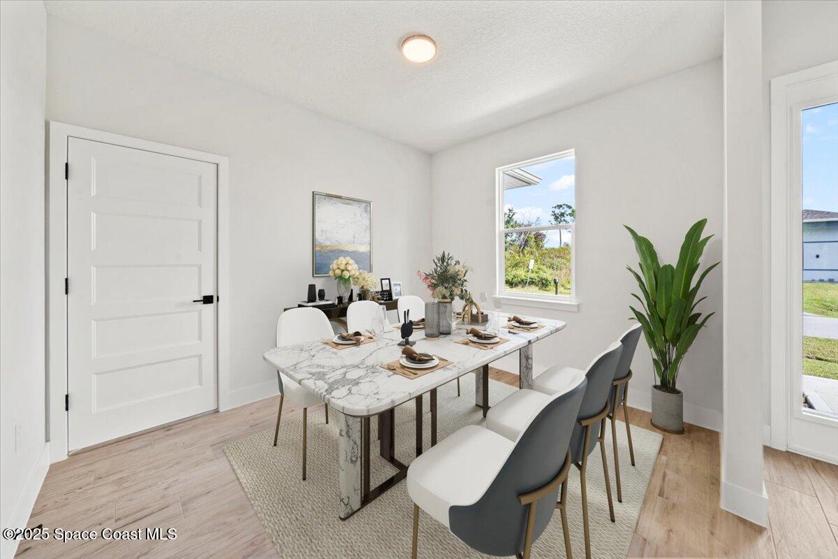 1401 Wilder Road Palm Bay, FL 32909 - Photo 8 of 21 a view of a dining room with furniture and wooden floor