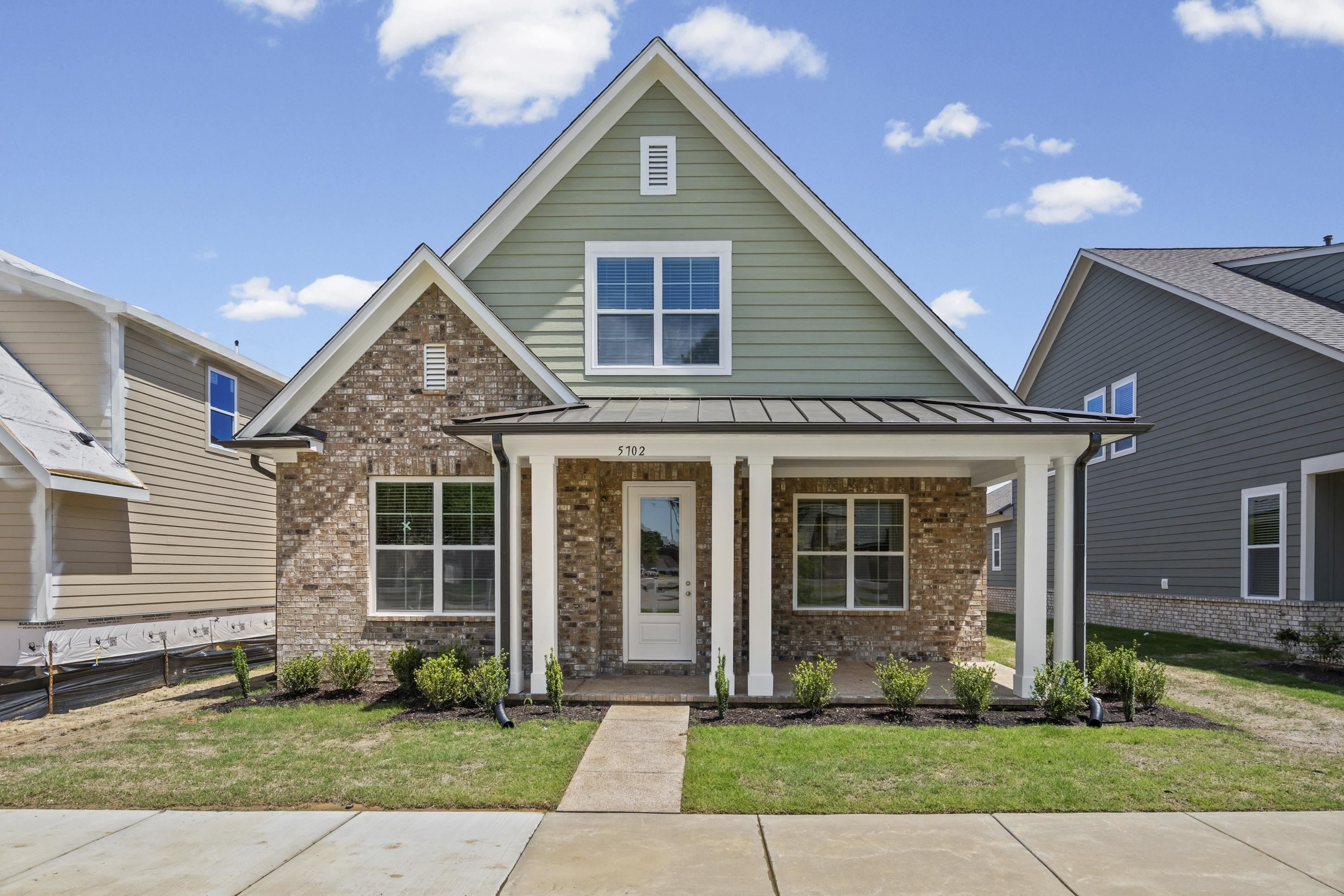 Traditional architecture featuring a brick and siding exterior
