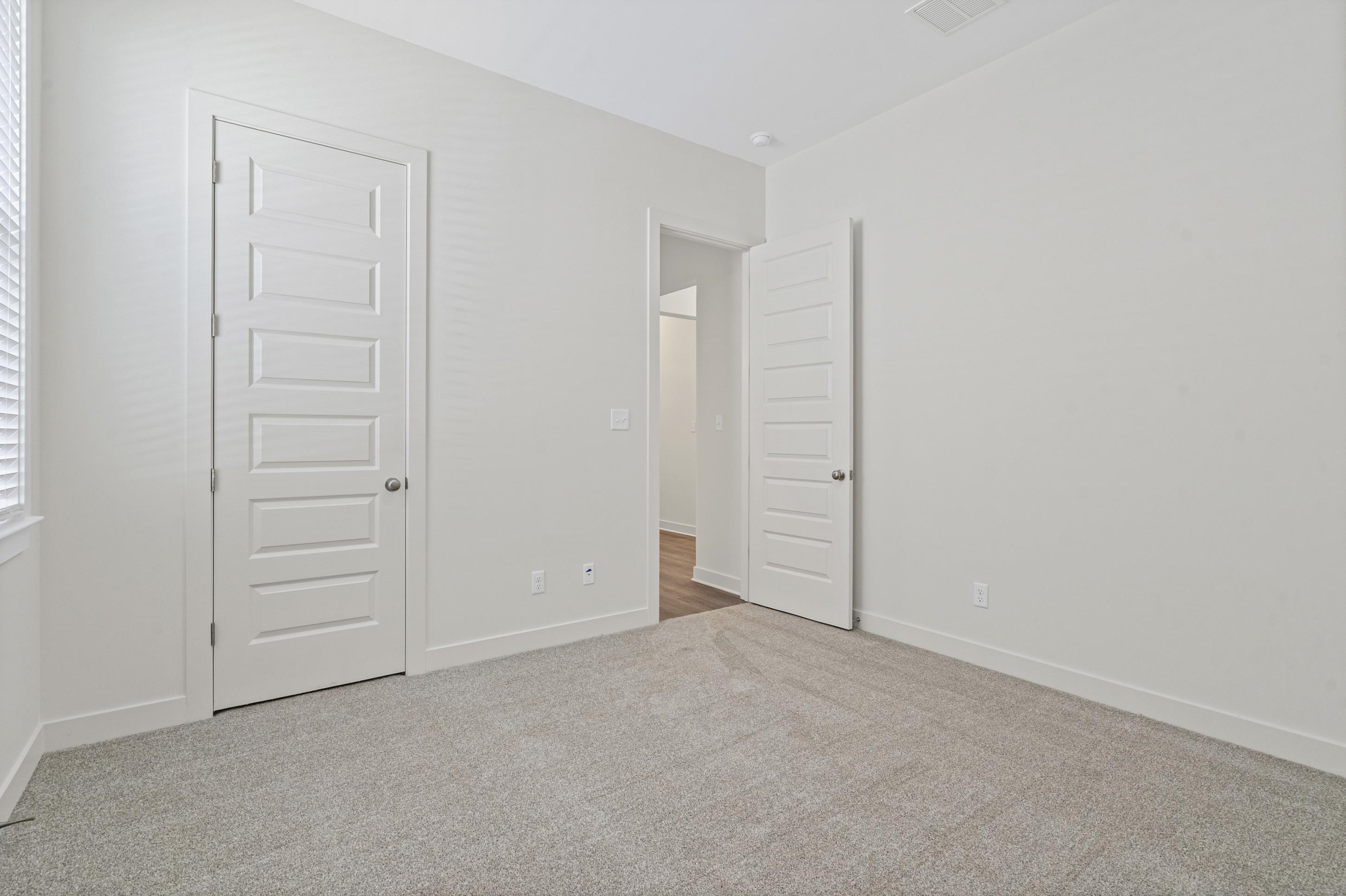 5702 Gerber Road Arlington, TN 38002 - Photo 16 of 27 Neutral-toned room with light gray carpeting, white painted walls, and white baseboards