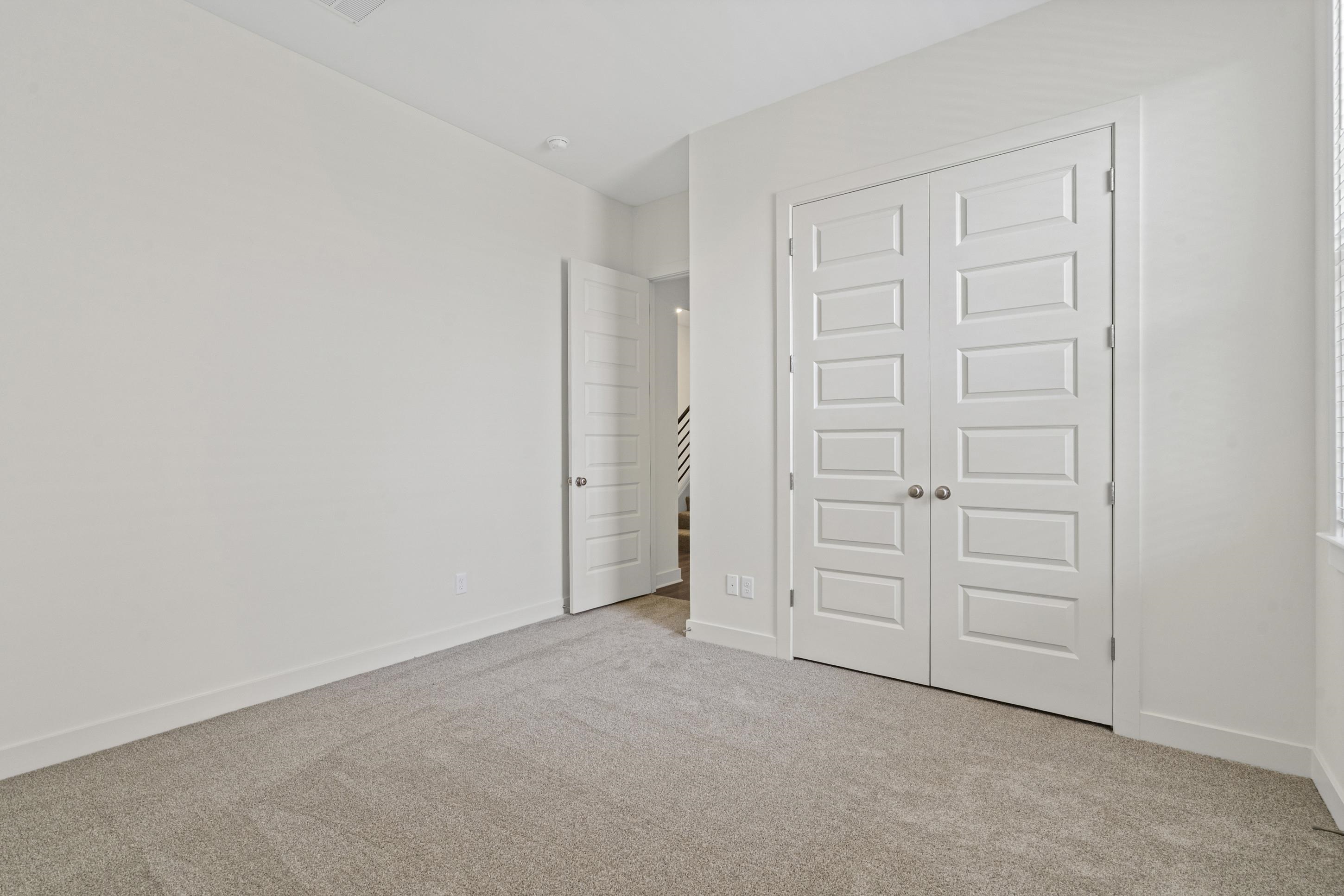 5702 Gerber Road Arlington, TN 38002 - Photo 19 of 27 Neutral-toned carpeting paired with white walls, baseboards, and trim