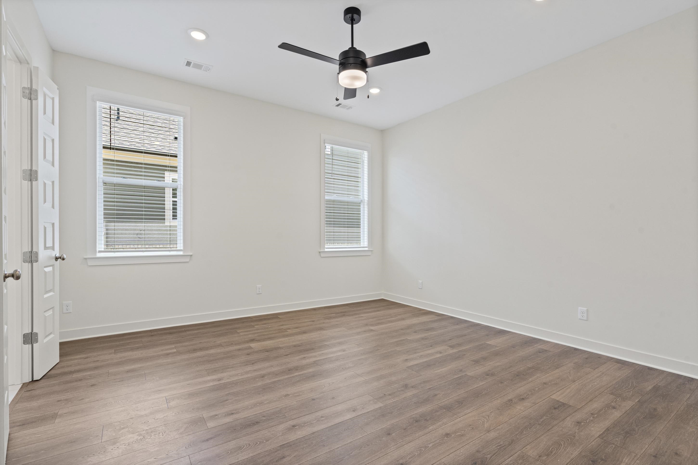 5702 Gerber Road Arlington, TN 38002 - Photo 10 of 27 Spacious interior featuring wood-finish flooring, two windows with blinds, recessed lighting, and a ceiling fan