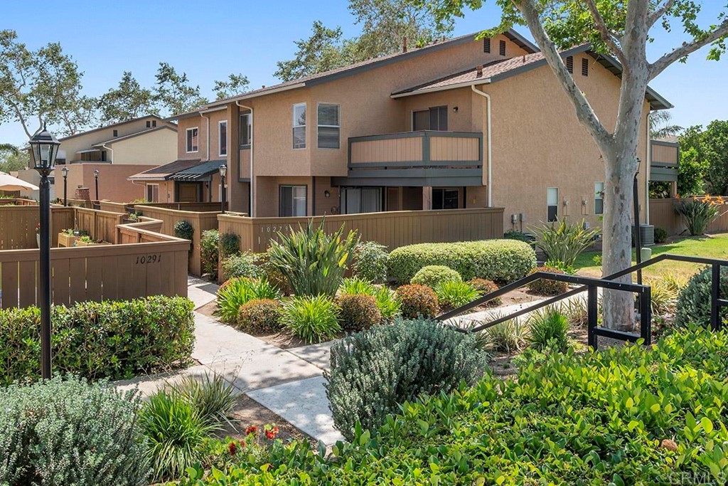 10281 Alphonse Street Santee, CA 92071 - Photo 1 of 26 a front view of a house with a yard and potted plants