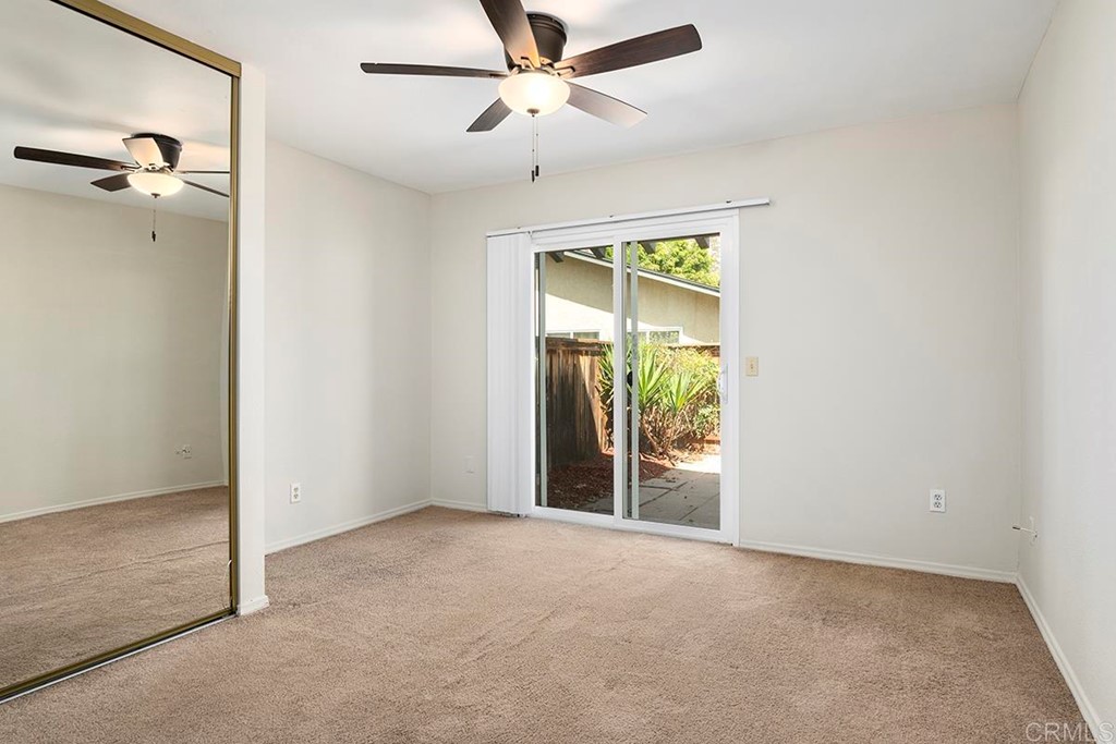 10281 Alphonse Street Santee, CA 92071 - Photo 14 of 26 an empty room with a ceiling fan and a window
