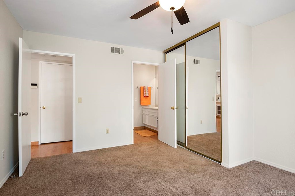 10281 Alphonse Street Santee, CA 92071 - Photo 15 of 26 an empty room with closet and a chandelier fan