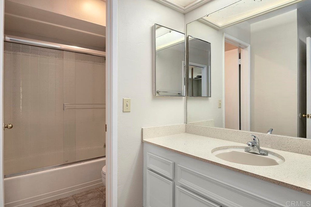 10281 Alphonse Street Santee, CA 92071 - Photo 19 of 26 a bathroom with a granite countertop sink mirror and vanity