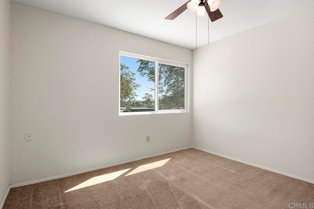 10281 Alphonse Street Santee, CA 92071 - Photo 20 of 26 an empty room with a window and a fan