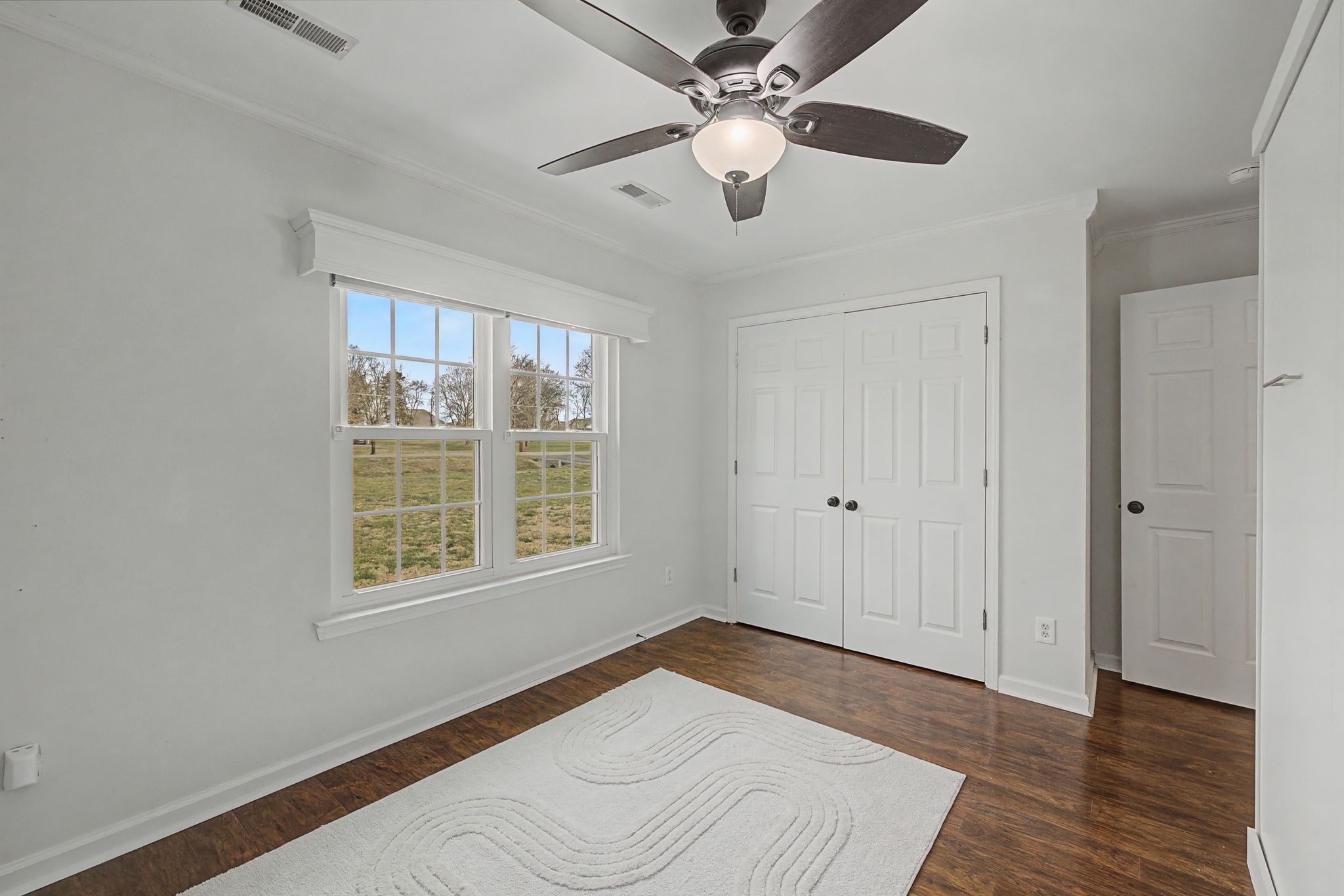 1123 Bramble Trail Murfreesboro, TN 37129 - Photo 27 of 41 a view of an empty room with wooden floor and a window