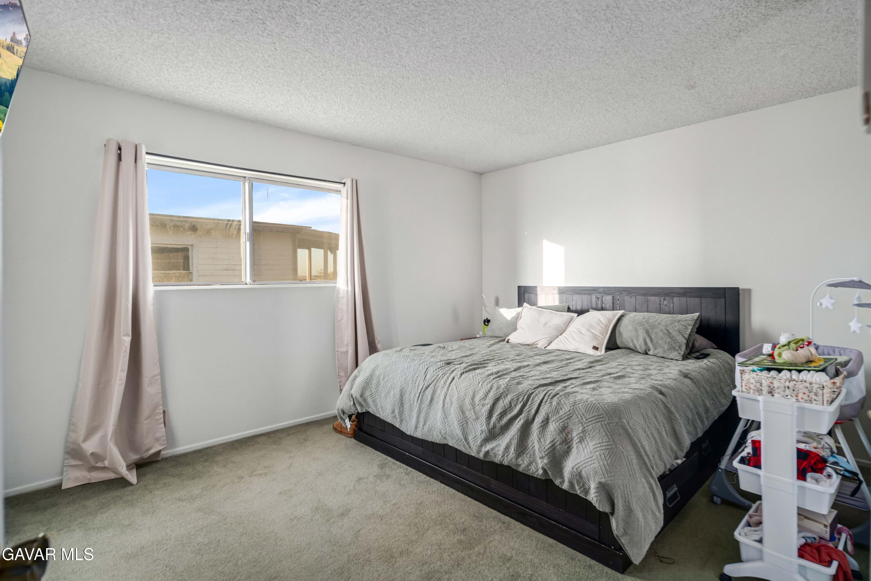 20539 East Ave R Palmdale, CA 93591 - Photo 27 of 55 a bedroom with a bed and a window