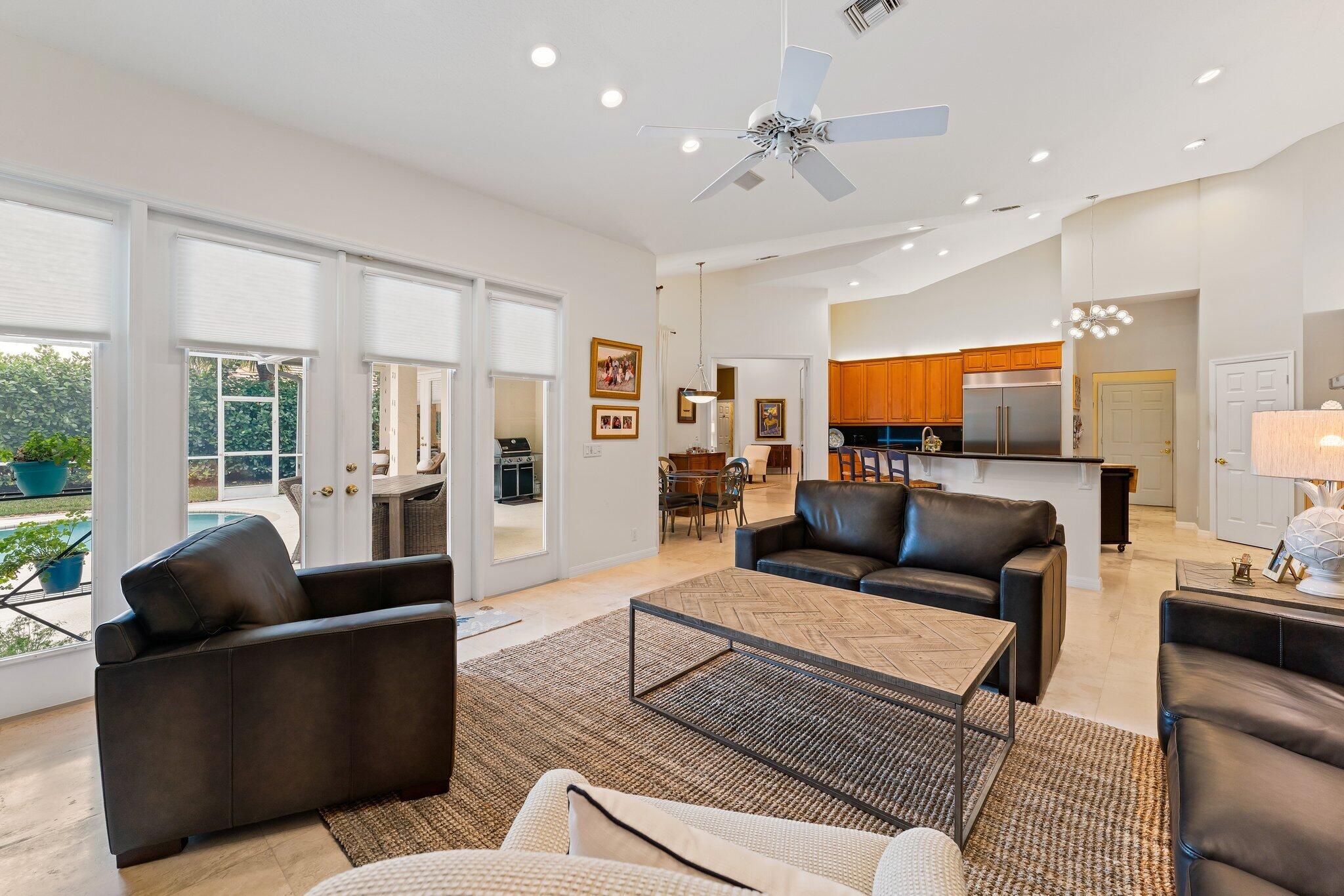 248 River Drive Tequesta, FL 33469 - Photo 19 of 65 a living room with furniture kitchen view and a large window