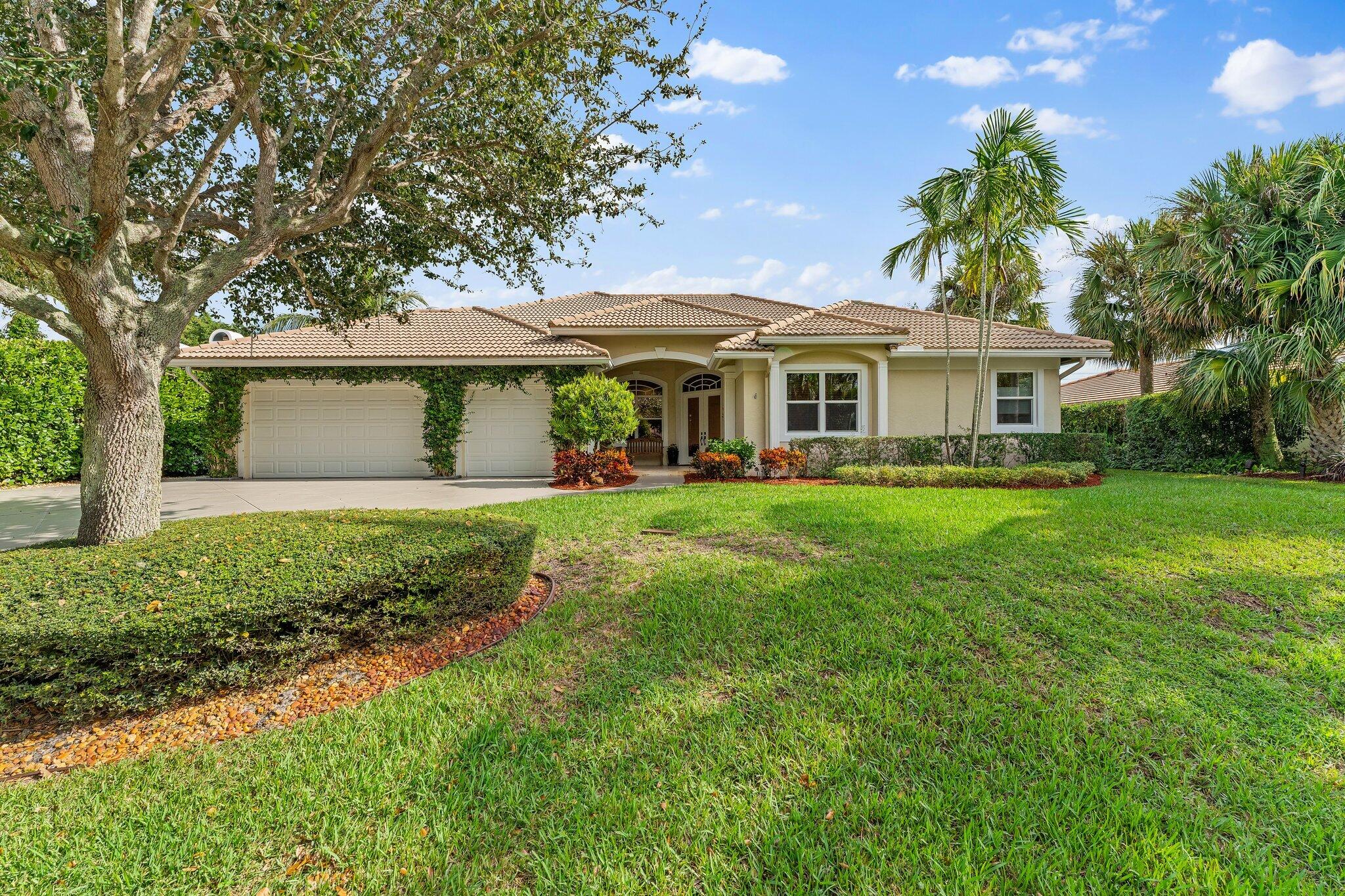 248 River Drive Tequesta, FL 33469 - Photo 43 of 65 a front view of house with yard and green space