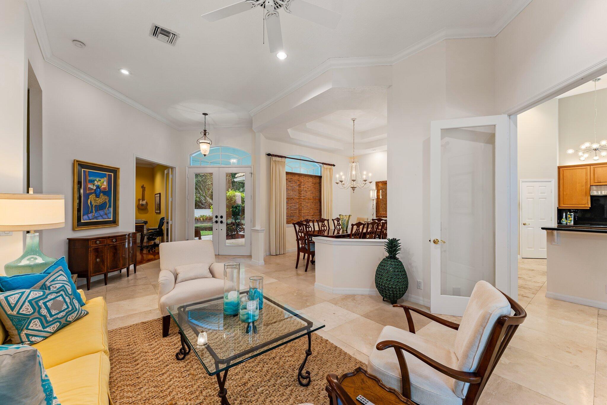 248 River Drive Tequesta, FL 33469 - Photo 49 of 65 a living room with furniture a dining table and chairs with kitchen view