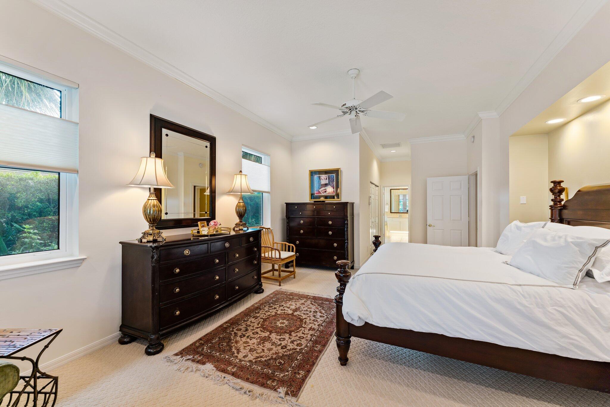 248 River Drive Tequesta, FL 33469 - Photo 54 of 65 a bedroom with a bed and wooden floor