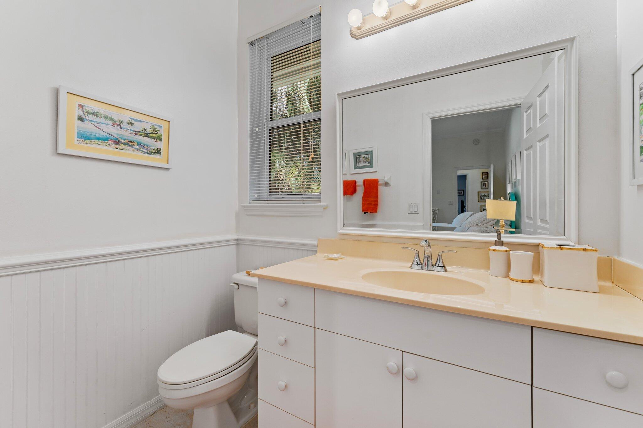 248 River Drive Tequesta, FL 33469 - Photo 58 of 65 a bathroom with a toilet sink and mirror
