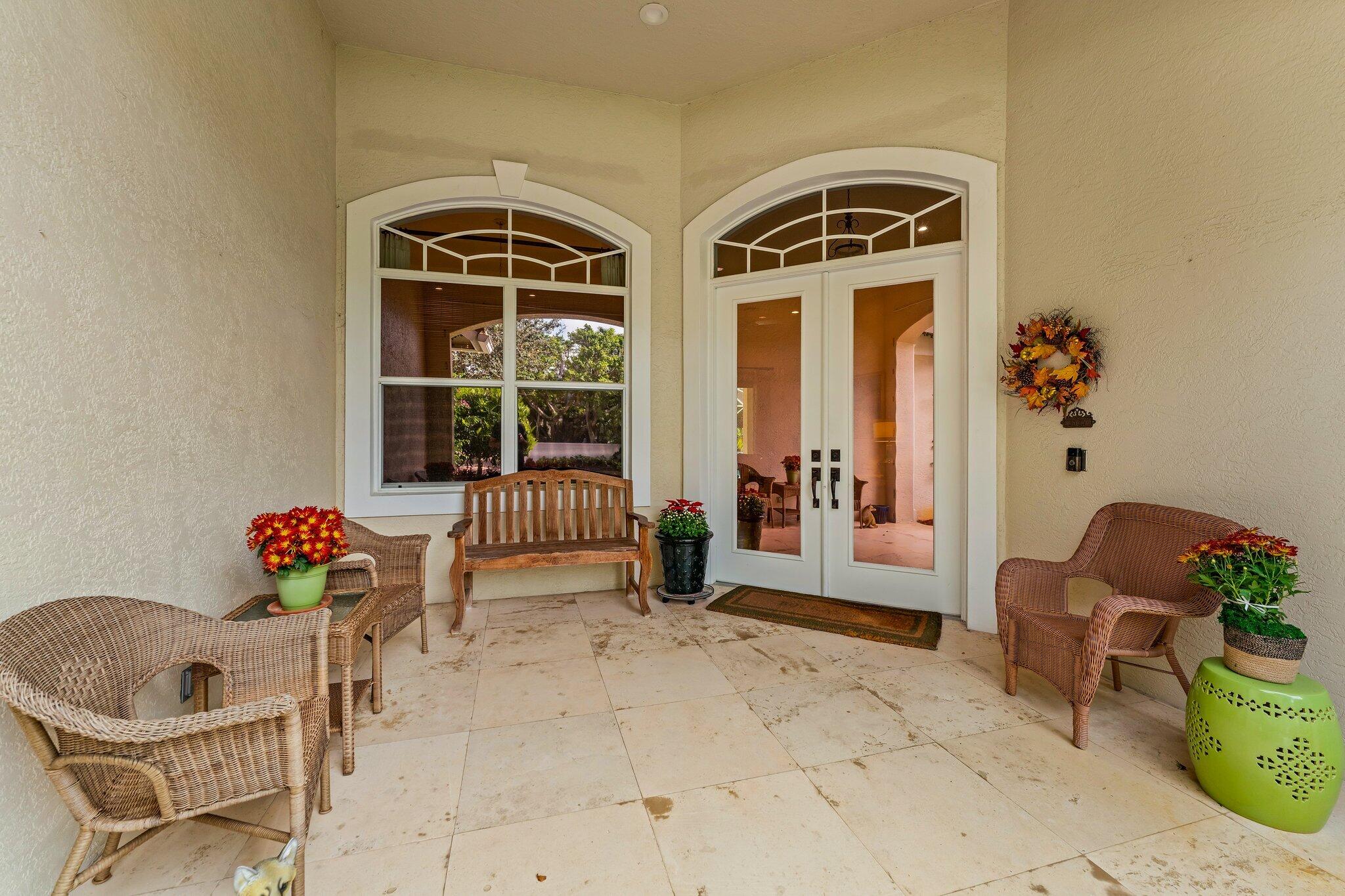 248 River Drive Tequesta, FL 33469 - Photo 6 of 65 a front view of a house with outdoor seating