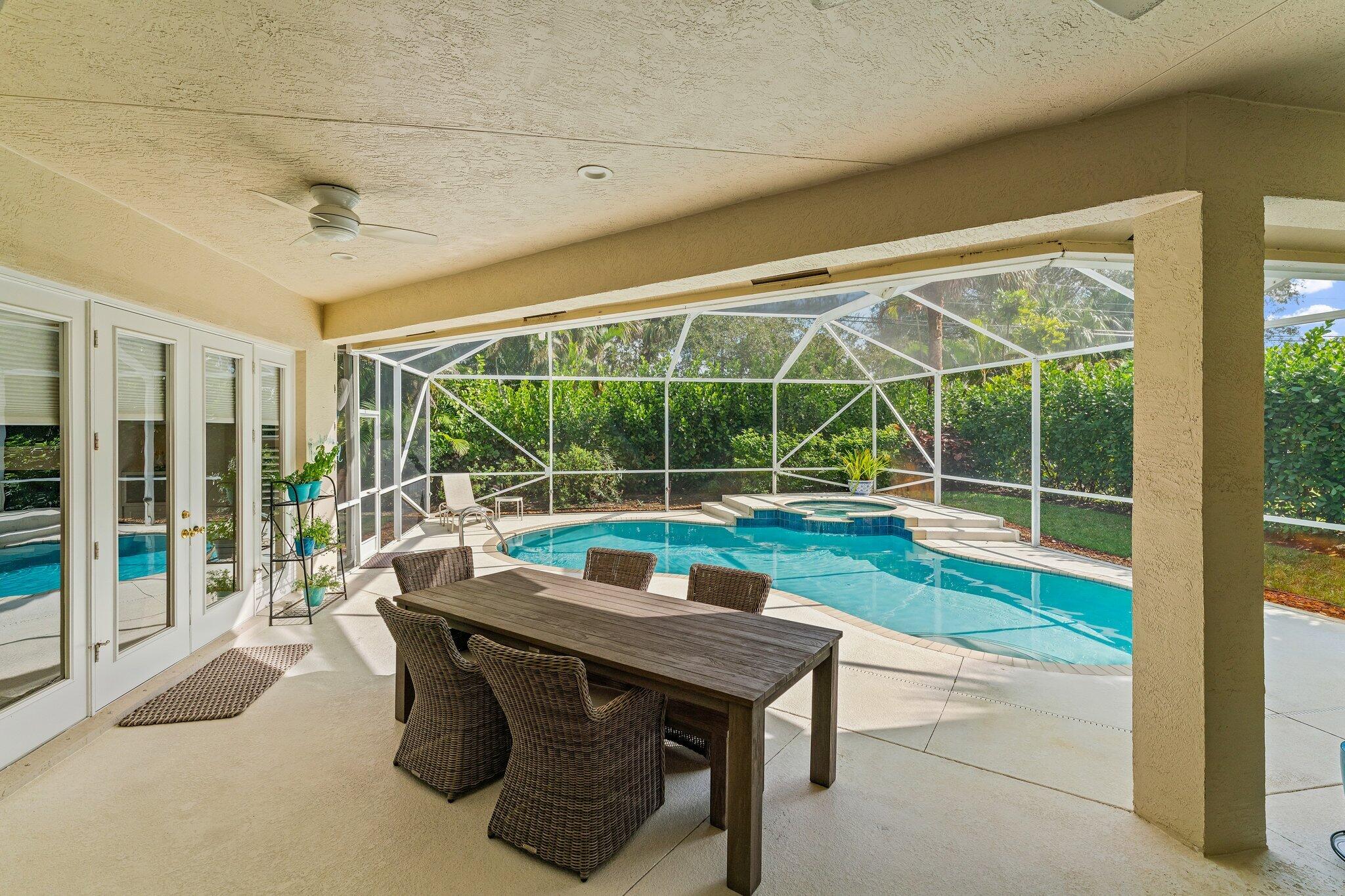248 River Drive Tequesta, FL 33469 - Photo 61 of 65 a view of a patio with a table chairs and a backyard