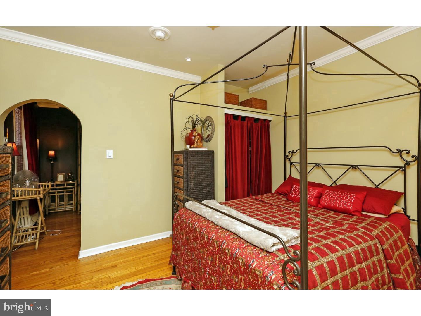 2306 Spruce Street, Unit 100 Philadelphia, PA 19103 - Photo 12 of 19 a bedroom with a bed and a view of bathroom