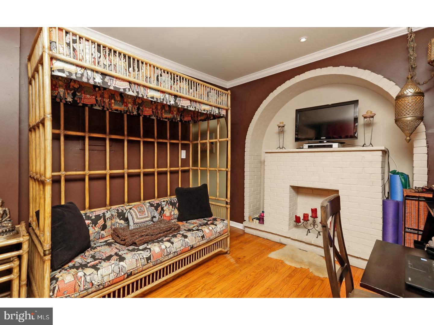 2306 Spruce Street, Unit 100 Philadelphia, PA 19103 - Photo 14 of 19 a view of living room with furniture and fireplace