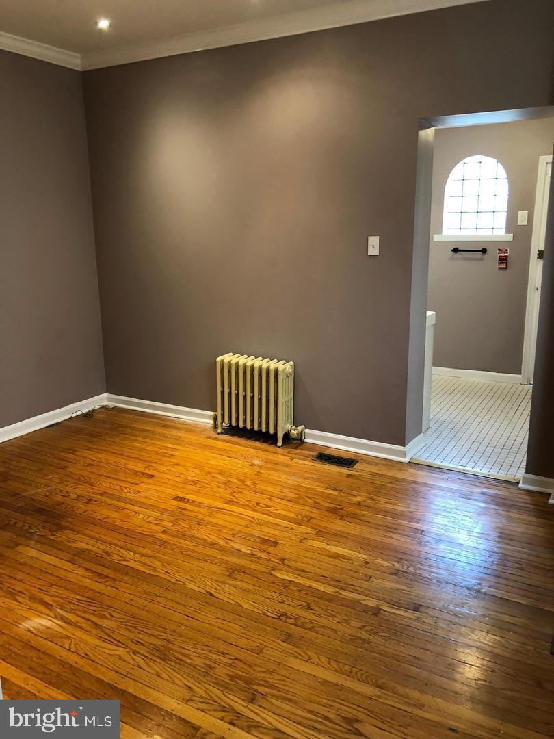 2306 Spruce Street, Unit 100 Philadelphia, PA 19103 - Photo 4 of 19 an empty room with wooden floor and windows