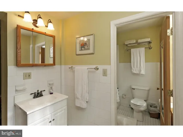 a bedroom with a bed and a mirror