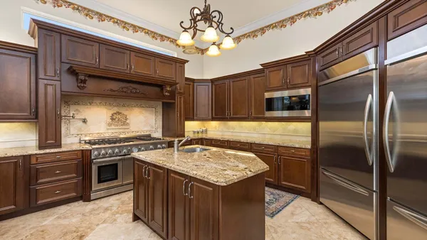 a kitchen with a stove sink and refrigerator
