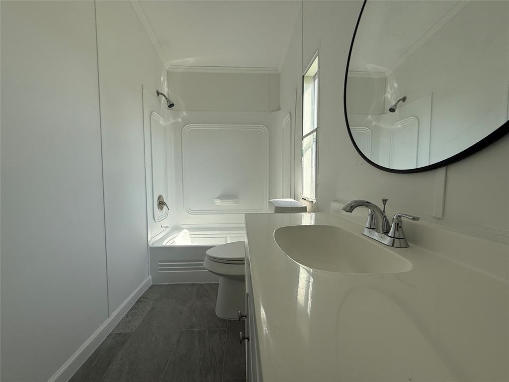 835 Private Road 4732 Rhome, TX 76078 - Photo 11 of 30 a bathroom with a sink a toilet and a mirror