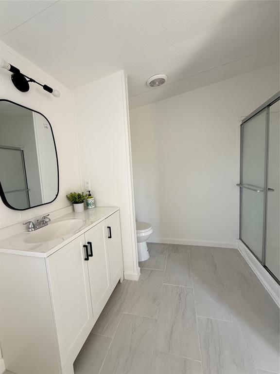835 Private Road 4732 Rhome, TX 76078 - Photo 18 of 30 a bathroom with a sink a toilet and mirror
